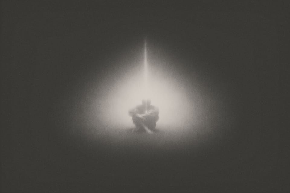 Person in Muraqaba meditation under a beam of light; spiritual art inspired by Khawaja Shamsuddin Azeemi.